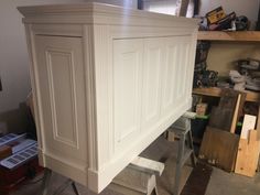 an unfinished cabinet in the process of being built