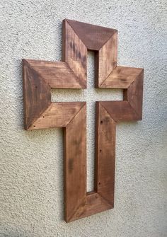 a wooden cross mounted to the side of a wall