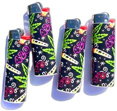 three lighters with designs on them sitting next to each other