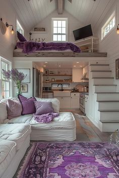 a living room filled with furniture and a purple rug