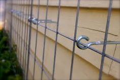 an image of a close up view of a fence with bars and hooks on it