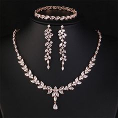 Complete your bridal look with our exquisite Leaf Bridal Jewelry Set. Featuring a stunning necklace, earrings, bracelet, and ring, this set is adorned with clear cubic zirconia stones, designed to complement any wedding dress beautifully. Available in silver, rose gold, and gold, this elegant set is the perfect choice for brides seeking timeless sophistication on their special day. Key Features: Elegant leaf design Includes necklace, earrings, bracelet, and ring Adorned with clear cubic zirconia Formal Rose Gold Crystal Jewelry, Delicate Diamond Jewelry For Party, Fine Cubic Zirconia Jewelry Sets For Wedding, Delicate Diamond Jewelry With Elegant Design, Rose Gold Fine Jewelry Sets For Formal Occasions, Rose Gold Cubic Zirconia Jewelry For Wedding, Delicate Crystal Jewelry For Anniversary, Formal Delicate Jewelry With Elegant Design, Formal Rose Gold Crystal Jewelry Sets