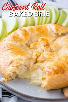 a close up of a pie on a plate with apples and cinnamon sticks in the background