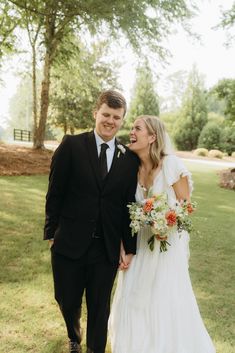 a bride and groom smile at each other