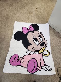 a crocheted minnie mouse rug on the floor