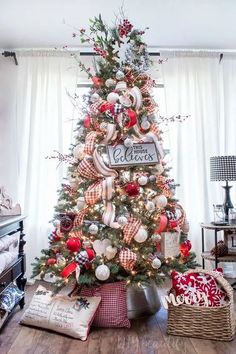 a christmas tree decorated with red, white and silver ornaments