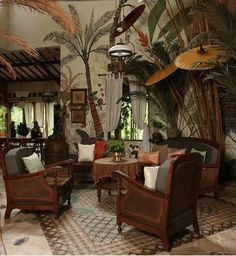 a living room filled with furniture and lots of palm trees