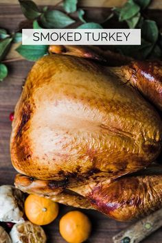 a roasted turkey on a wooden cutting board with spices and herbs around it text reads smoked turkey