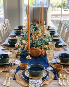 a table set with blue and gold place settings