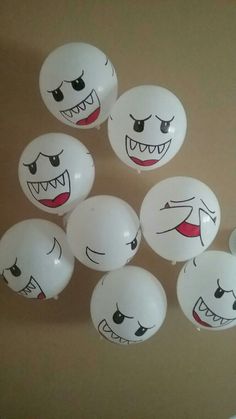 white balloons with faces painted on them