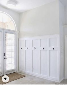 an empty room with white walls and doors