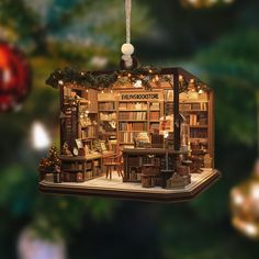 an ornament shaped like a book store with christmas lights and decorations hanging from the ceiling