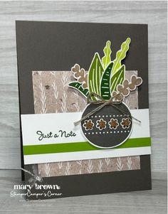 a handmade card with a potted plant on the front and green trimmings