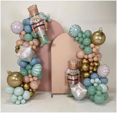 a balloon arch with a nutcracker and other decorations