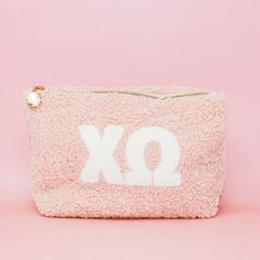 Carry around all your must-haves in style with this Sorority Letter Teddy Pouch! Perfect for throwing into a bag or toting around separately, this cute lil' pouch is made of soft sherpa material and features a gold zipper detail with a retro floral interi Big/little Baskets, Green Bay Packers Shirts, Sorority Letters, Sorority Big Little, Patriotic Fashion, Gamma Phi Beta, Clothing Gifts, Elegant Baby, Keychain Wallet