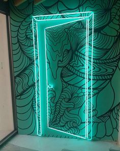 an open door is lit up in front of a green wall