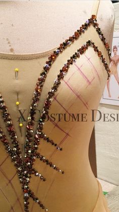 a mannequin is adorned with beads and beaded necklaces on it's back