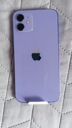 an iphone case sitting on top of a bed