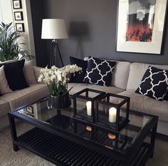 a living room with two couches, a coffee table and some candles on it