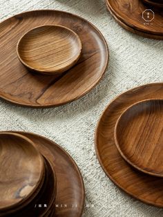 wooden plates and bowls are laid out on the floor