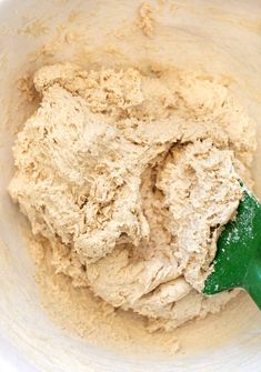 a mixing bowl filled with batter and a green spatula