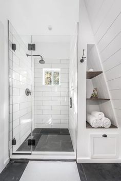 a walk in shower sitting inside of a bathroom