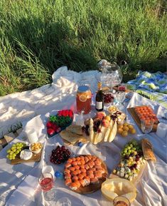 an outdoor picnic with food and drinks on the table