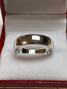 a silver ring sitting in a red box