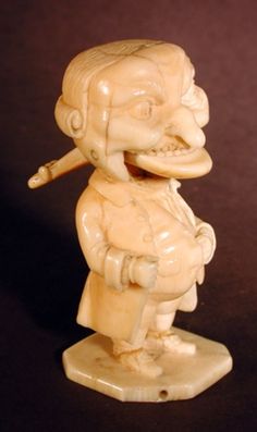 an ivory figurine of a boy with a pipe in his mouth, on a black background