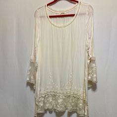 Tunic In Excellent Condition. Cream Colored. Long Sleeves. Size Large. Beautiful Lace Embellishment Through Out. 100% Rayon 100% Nylon Trim Hand Wash. Pit To Pit: 21” Sleeve: 23” Neck To Hem: 31” Fitted Off White Top With Lace Trim, Fitted Bohemian Top With Lace Sleeves, Fitted Off White Lace Top For Summer, Cream Stretch Blouse For Summer, Summer Stretch Lace Blouse, Bohemian Spring Stretch Lace Top, Bohemian Stretch Lace Top For Spring, Fitted Off-white Lace Top For Spring, Fitted Off White Bohemian Tops