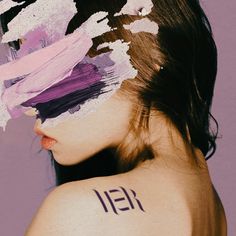 a woman with her face covered in paint and the word'13 11 written on her back