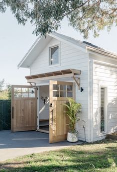 a small white house with a wooden door