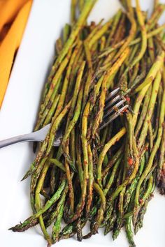 asparagus on a white plate with a fork