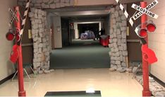 a hallway with rocks and signs on the walls that say stop driving in front of it