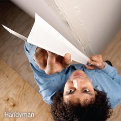 a man holding a piece of paper above his head