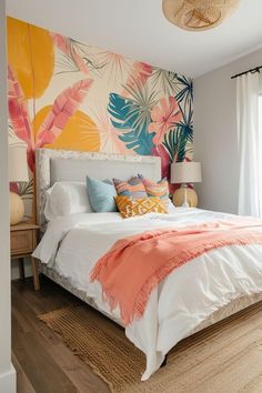 a large bed sitting in a bedroom next to a window covered in colorful wallpaper