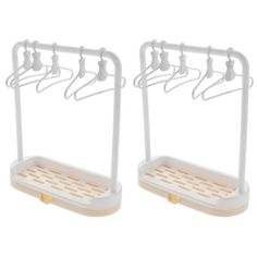 two white clothes hangers with hooks on each side and one hanging over the other