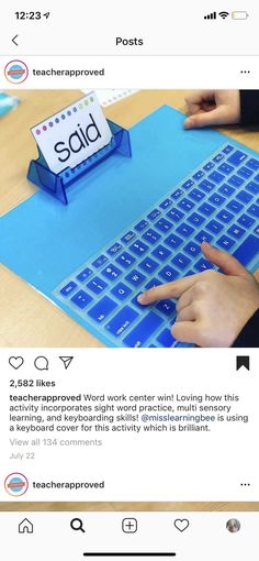 someone is typing on a blue keyboard with the word said written on it and another hand pointing