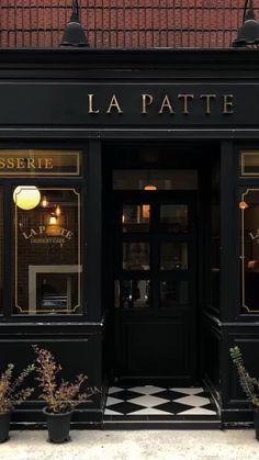 the front entrance to la patte restaurant with black and white checkered flooring