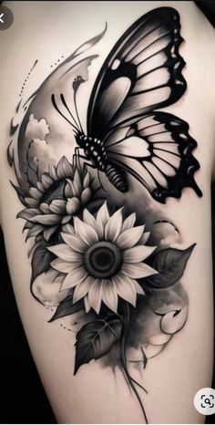 a butterfly and sunflower tattoo on the back of a woman's thigh,