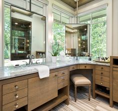 a large bathroom with two sinks and mirrors