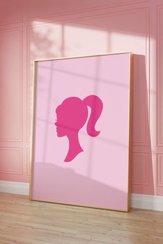 a pink poster with a silhouette of a woman's head against a pink wall