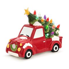 a red toy truck with a christmas tree on the top and lights in the back