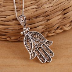 This is solid 925 sterling silver filigree Hamsa-Hand of Fatima Good Luck pendant. Hamsa Hand of Fatima is a symbol of good luck. 925 stamped. Approx. measures:                  total length: 37mm                 without bail: 28mm                 width : 20mm Approx. weight: 2.8gr. pendant only. Available on its own or with various length (16-30 Inch ) 1mm curb chain, please choose from the drop down menu at the top of the page. Presented in gift box! Thank you for looking! Antique Silver Spiritual Jewelry With Intricate Design, Spiritual Antique Silver Jewelry With Intricate Design, Sterling Silver Spiritual Necklace With Intricate Design, Spiritual Sterling Silver Necklace With Intricate Design, Spiritual Silver Necklace With Intricate Design, Traditional Sterling Silver Clasp Jewelry Gift, Traditional Jewelry Gift With Sterling Silver Clasp, Traditional Sterling Silver Clasp Jewelry As A Gift, Sterling Silver Jewelry With Filigree In Silver