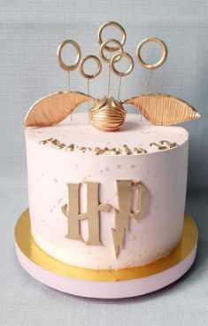 a white cake with gold decorations on top