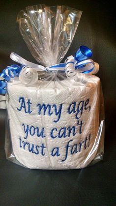 a toilet paper roll wrapped in plastic and tied with blue ribbon that says at my age, you can trust a farm