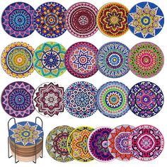 many colorful plates are arranged in rows on a white background and one has a metal stand