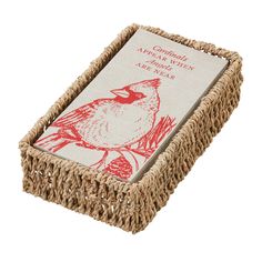 a small basket with a red bird on it