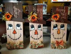 three wooden boxes decorated with pumpkin faces and sunflowers