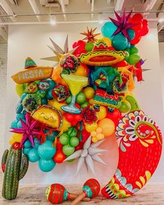 a large balloon sculpture made to look like a mexican hat and other items on display